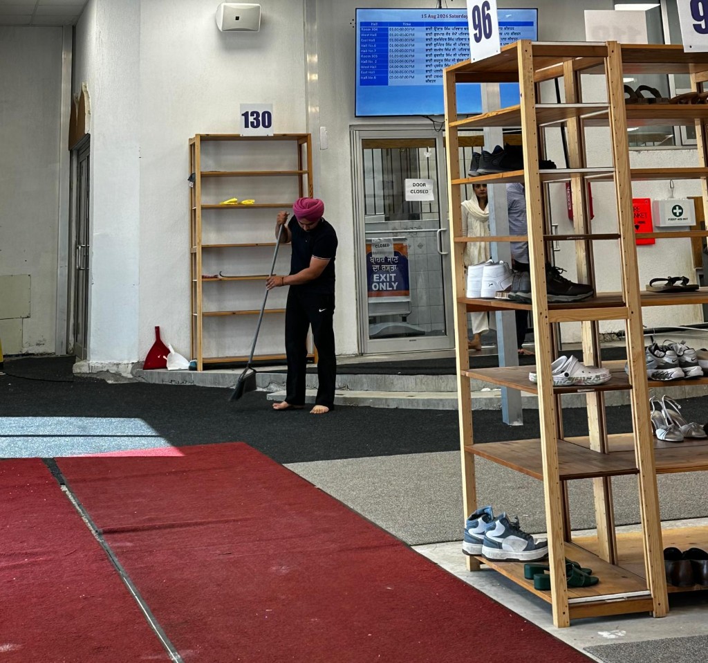 Volunteer sweeping and serving in the community space