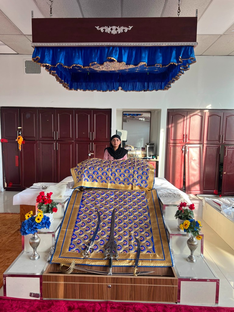 Palki Sahib with rumalas and shastar in the spiritual space